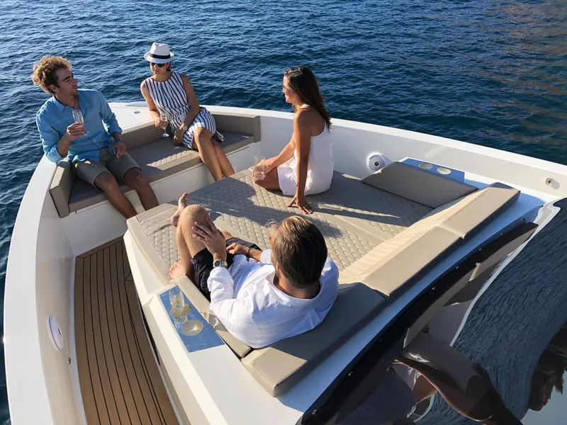 Slide: The Image of Four people relaxing on a 2024 De Antonio Yachts D42 Open, enjoying the ocean view. - 6