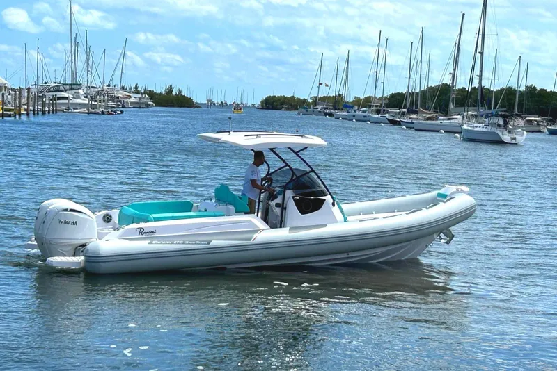 The Image of 2025 Ranieri CAYMAN 27.0 SPORT TOURING boat on a calm marina with sailboats. - 0