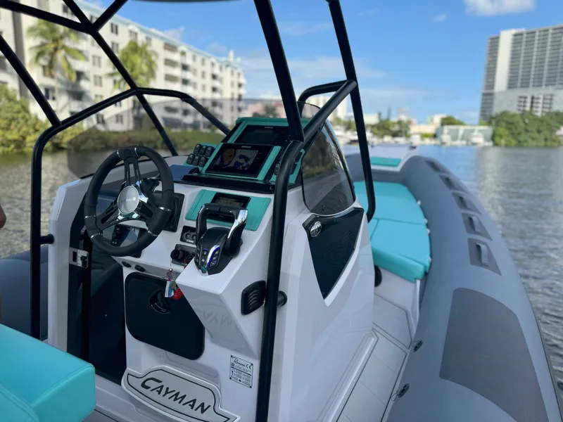 Slide: The Image of 2025 Ranieri CAYMAN 27.0 SPORT TOURING boat interior with modern controls and turquoise seating. - 15