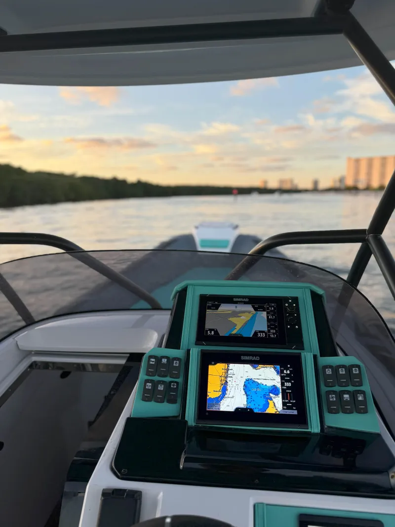 Slide: The Image of 2025 Ranieri CAYMAN 27.0 SPORT TOURING boat with advanced navigation system on a scenic waterway. - 19