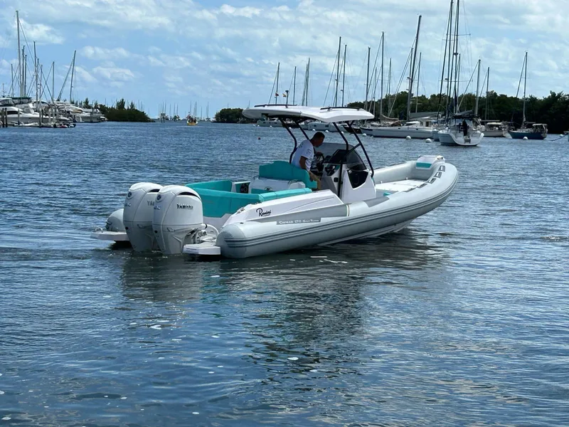 Slide: The Image of 2025 Ranieri CAYMAN 27.0 SPORT TOURING boat cruising in a marina. - 5