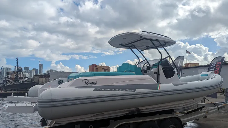Slide: The Image of 2025 Ranieri CAYMAN 27.0 SPORT TOURING boat docked at a marina. - 7