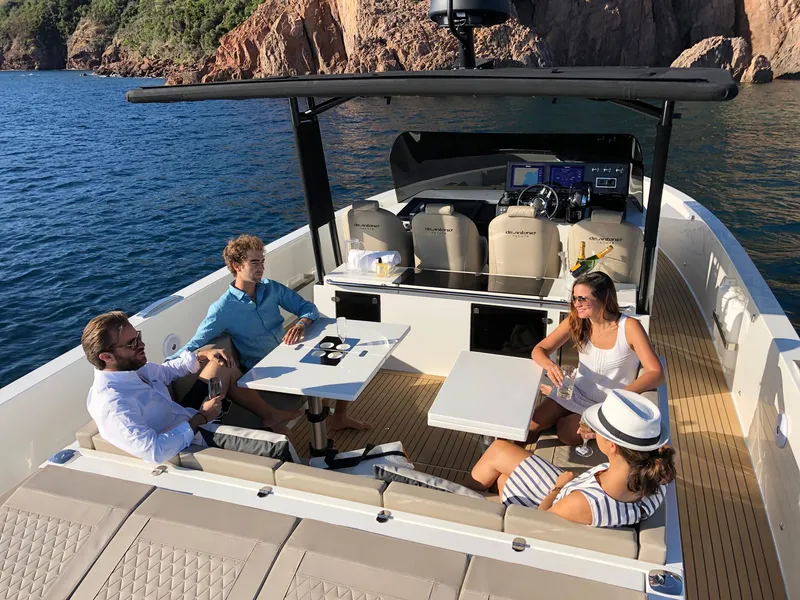 Slide: The Image of 2024 De Antonio Yachts D42 Open with people enjoying a sunny day on the water. - 5