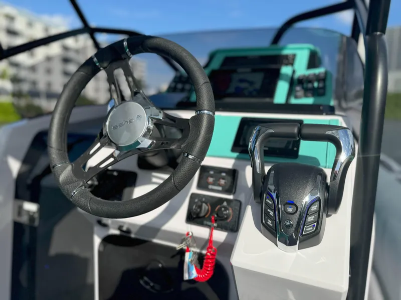 Slide: The Image of Steering wheel and controls of 2025 Ranieri CAYMAN 27.0 SPORT TOURING boat. - 11
