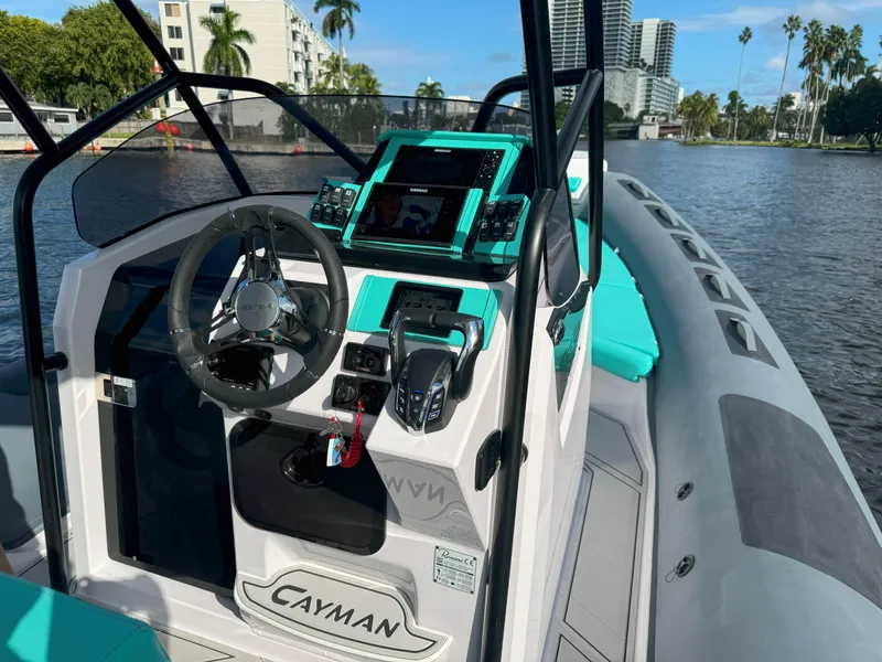 Slide: The Image of 2025 Ranieri CAYMAN 27.0 SPORT TOURING boat interior with modern dashboard and steering. - 12