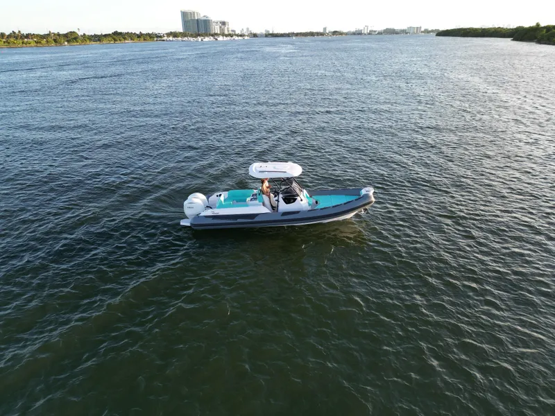 Slide: The Image of 2025 Ranieri CAYMAN 27.0 SPORT TOURING boat cruising on open water. - 2