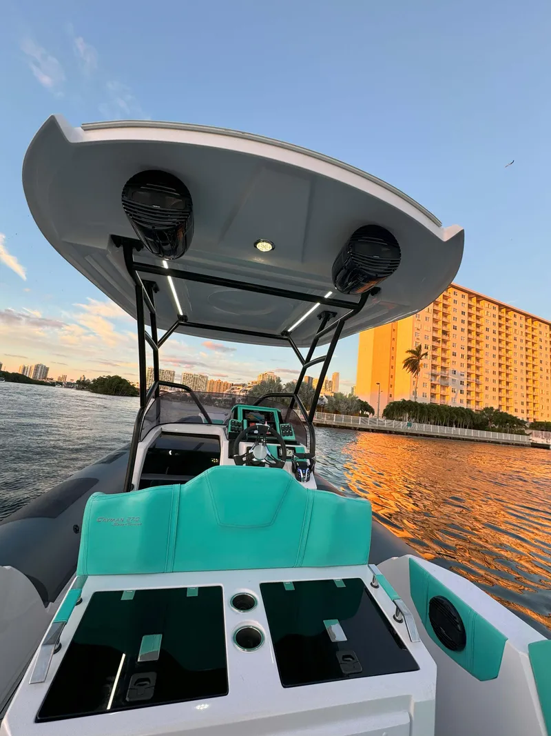 Slide: The Image of 2025 Ranieri CAYMAN 27.0 SPORT TOURING boat on water at sunset. - 29