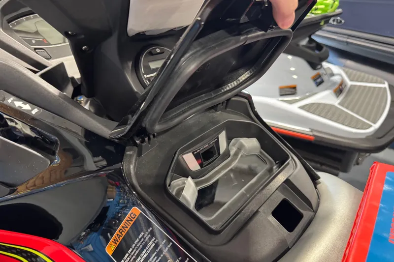 Slide: The Image of 2025 Kawasaki STX160LX storage compartment with open lid, showcasing interior details. - 11