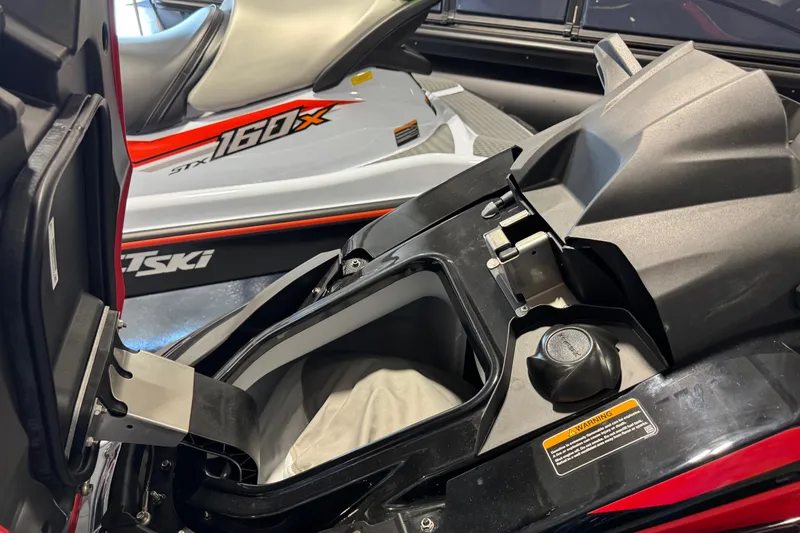 Slide: The Image of 2025 Kawasaki STX160LX jet ski with open storage compartment, showcasing sleek design. - 12