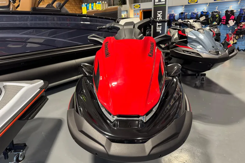 Slide: The Image of 2025 Kawasaki STX160LX jet ski in showroom, featuring sleek red and black design. - 4