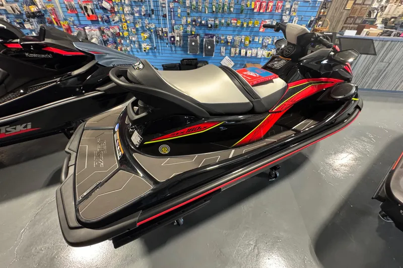 Slide: The Image of 2025 Kawasaki STX160LX jet ski in showroom, featuring sleek design and vibrant colors. - 5