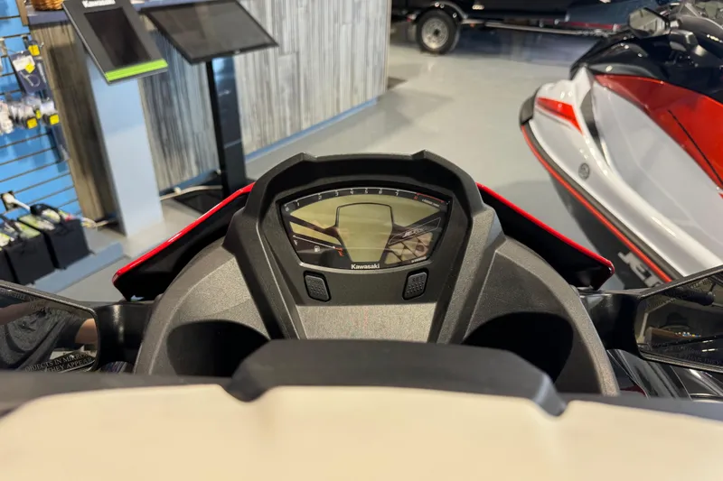 Slide: The Image of 2025 Kawasaki STX160LX dashboard in showroom, featuring modern display and controls. - 8