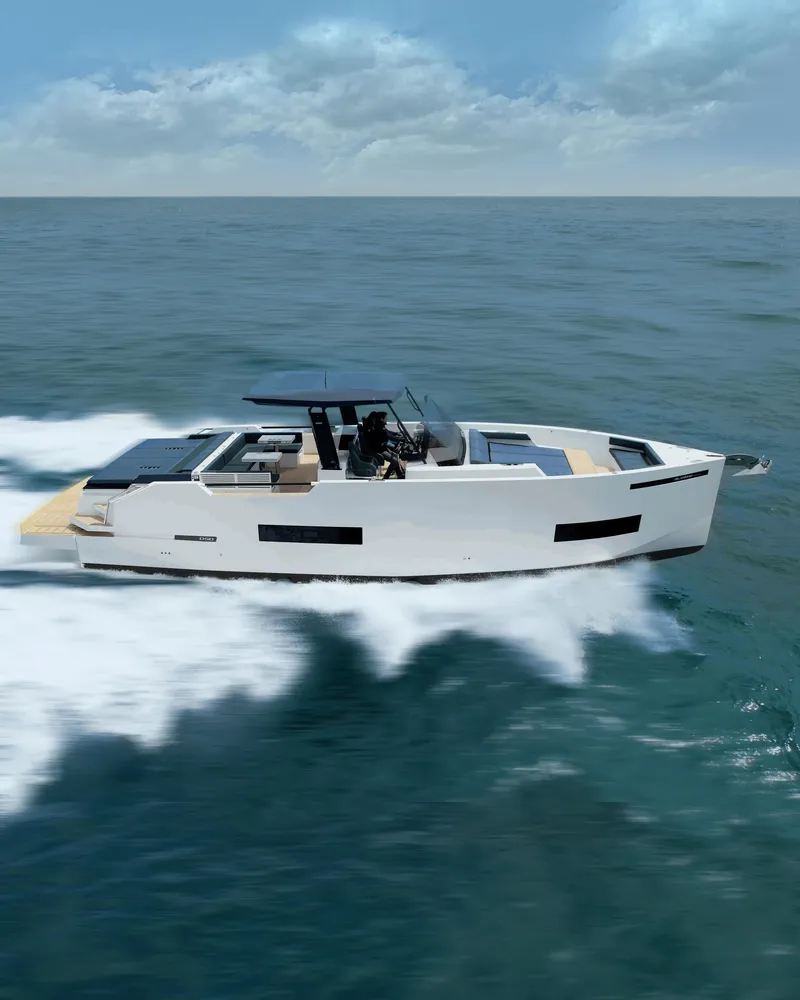 Slide: The Image of 2024 De Antonio Yachts D50 OPEN cruising on open water under a cloudy sky. - 9