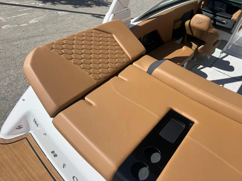Slide: The Image of 2023 Four Winns H4 boat with luxurious tan leather seating and cup holders. - 11