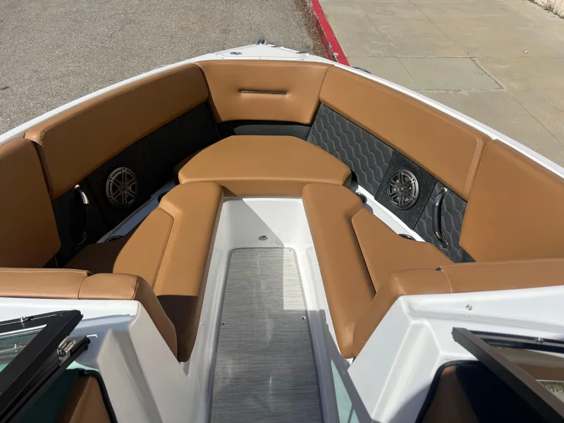 Slide: The Image of 2023 Four Winns H4 boat with tan leather seating and built-in speakers. - 15