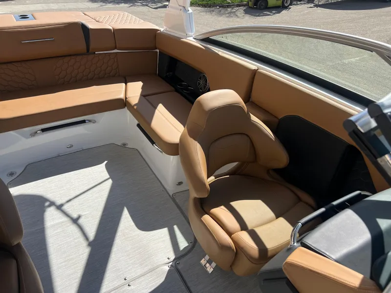 Slide: The Image of 2023 Four Winns H4 boat interior with tan leather seating and modern design. - 19