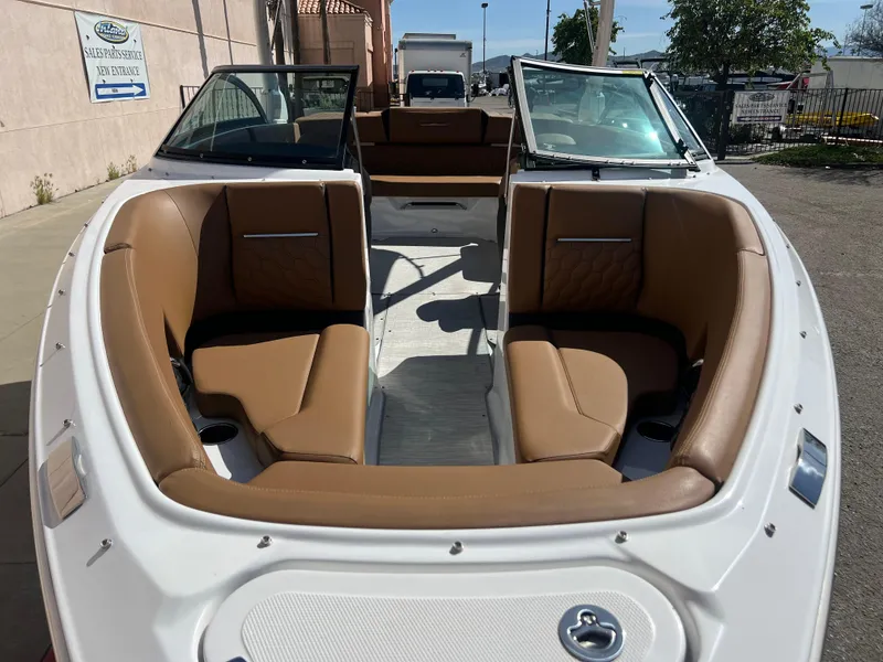 Slide: The Image of 2023 Four Winns H4 boat with tan leather seating and open bow design. - 2