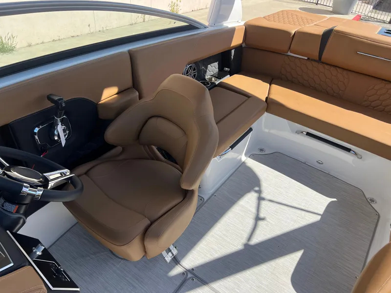 Slide: The Image of 2023 Four Winns H4 boat interior with tan leather seats and modern design. - 20