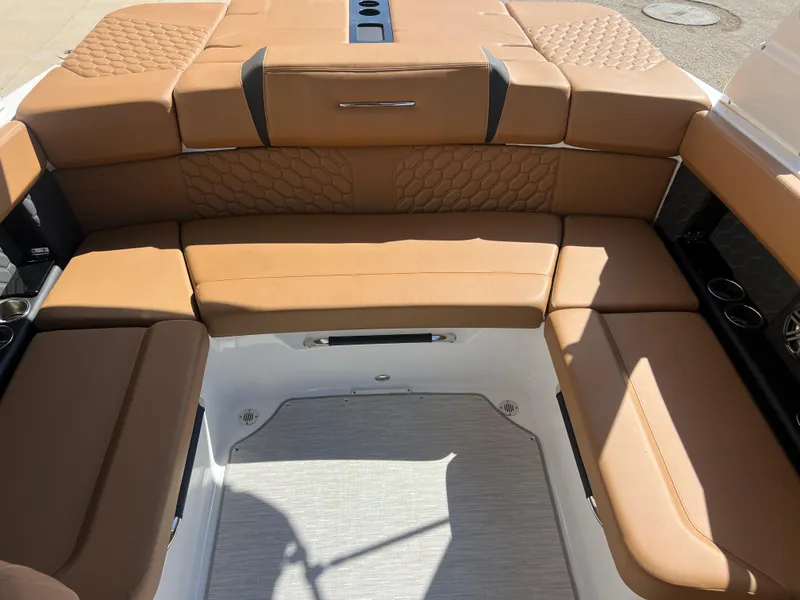 Slide: The Image of 2023 Four Winns H4 boat interior with tan leather seating and modern design. - 21