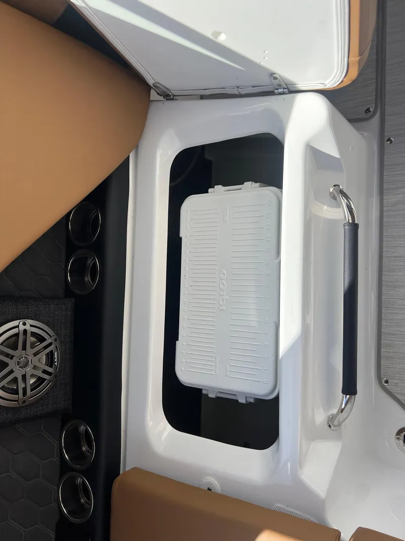 Slide: The Image of 2023 Four Winns H4 boat storage compartment with white cooler. - 22