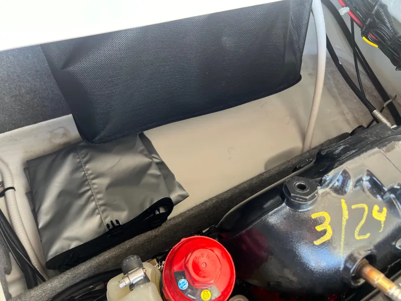Slide: The Image of Engine compartment of 2023 Four Winns H4 boat with storage and components. - 26