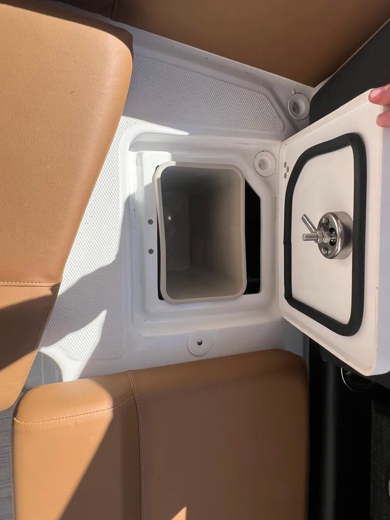 Slide: The Image of 2023 Four Winns H4 boat storage compartment with open lid. - 28