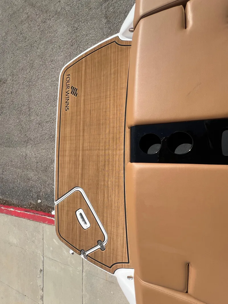 Slide: The Image of 2023 Four Winns H4 boat with tan deck and seating. - 30