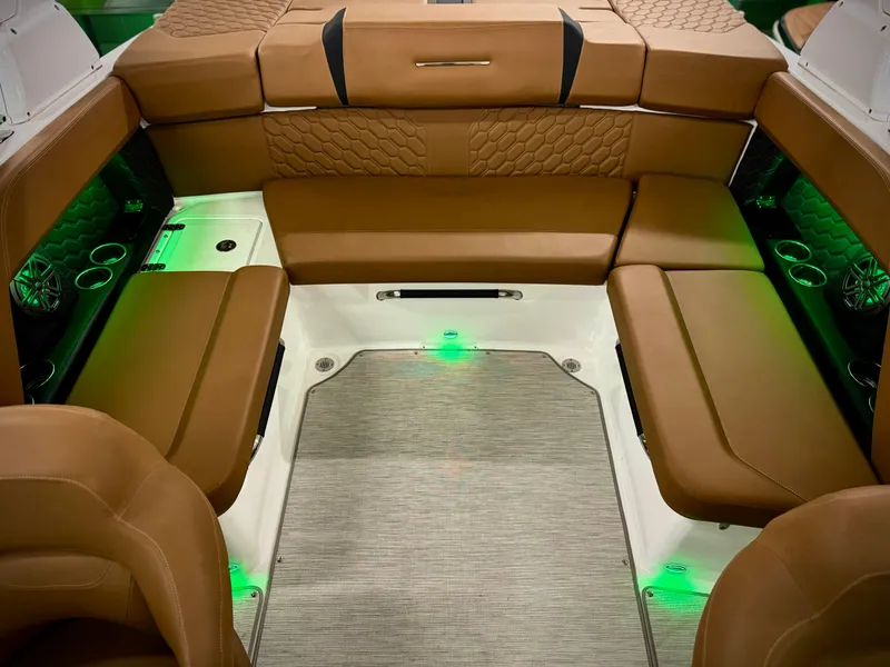 Slide: The Image of Luxurious interior of 2023 Four Winns H4 boat with brown leather seating and ambient lighting. - 34