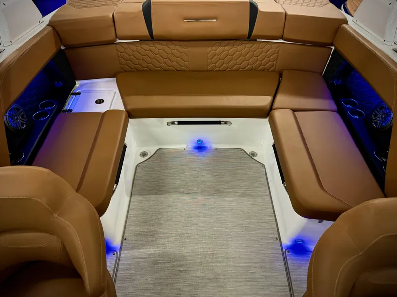 Slide: The Image of Luxurious interior of 2023 Four Winns H4 boat with brown leather seating and ambient lighting. - 35