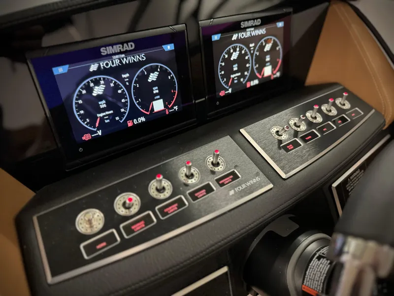 Slide: The Image of 2023 Four Winns H4 boat dashboard with Simrad displays and control panel. - 39