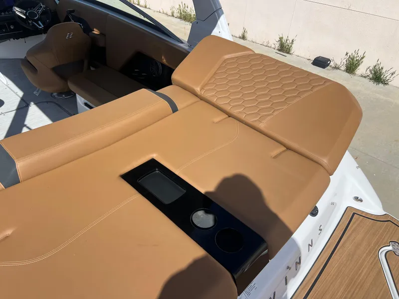 Slide: The Image of 2023 Four Winns H4 boat with tan leather seating and cup holders. - 9