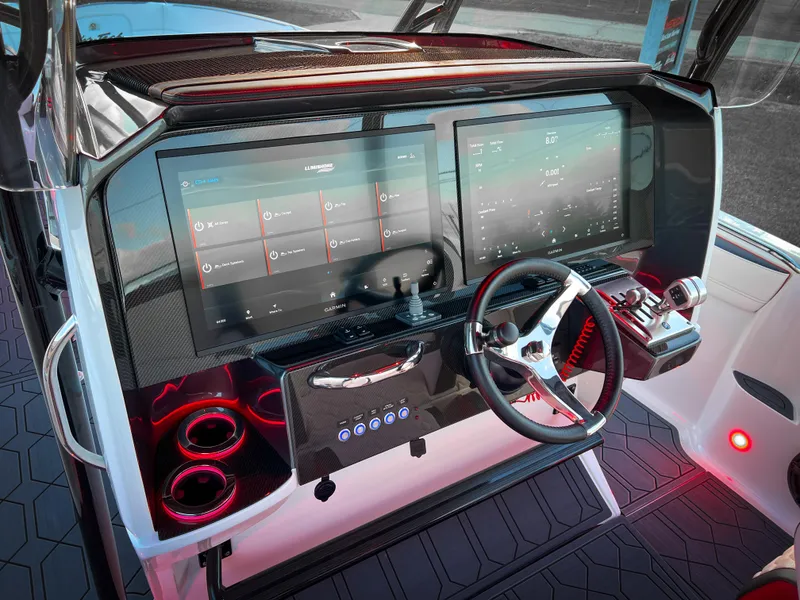 Slide: The Image of 2025 Nor-Tech 390 Sport boat dashboard with dual screens and modern controls. - 14