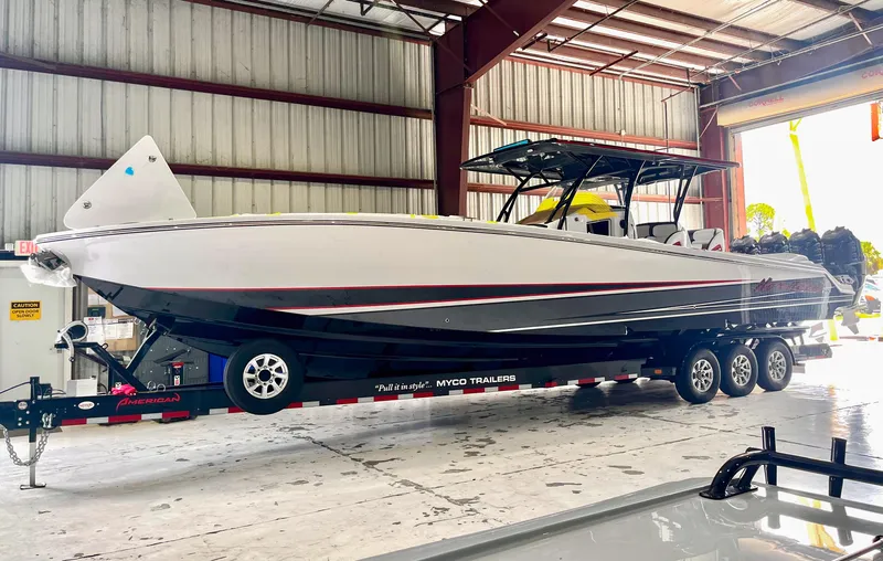Slide: The Image of 2025 Nor-Tech 390 Sport boat on trailer in warehouse setting. - 22