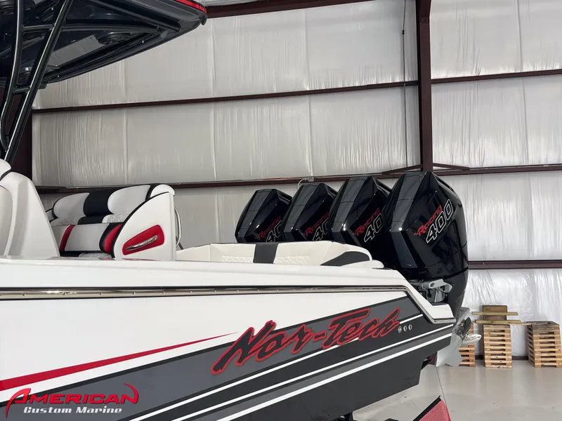 Slide: The Image of 2025 Nor-Tech 390 Sport boat with triple engines in a warehouse. - 24