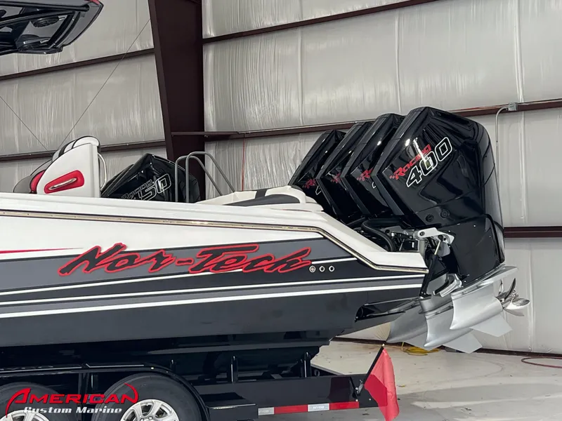 Slide: The Image of 2025 Nor-Tech 390 Sport boat with powerful 400 engines in a storage facility. - 25