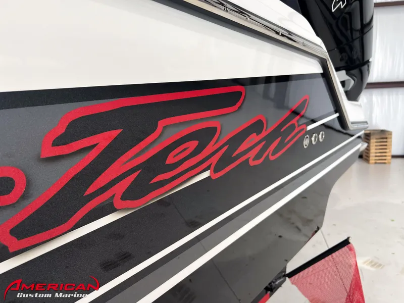 Slide: The Image of Nor-Tech 390 Sport 2025 boat with bold red logo in a showroom. - 26