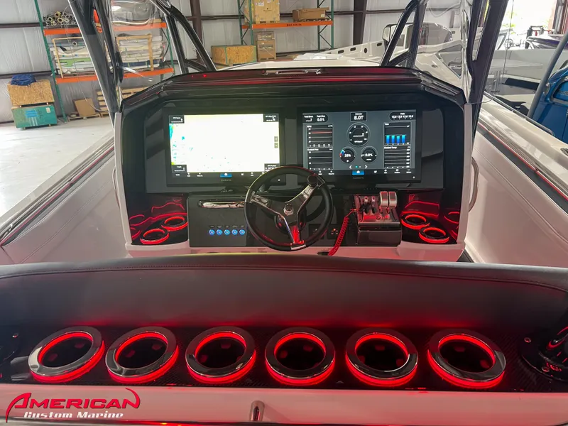 Slide: The Image of 2025 Nor-Tech 390 Sport boat dashboard with advanced navigation and control systems. - 28