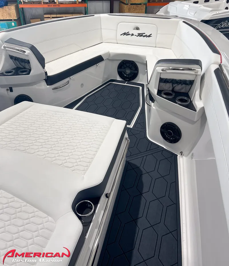 Slide: The Image of 2025 Nor-Tech 390 Sport boat interior with white seating and hexagonal floor design. - 30