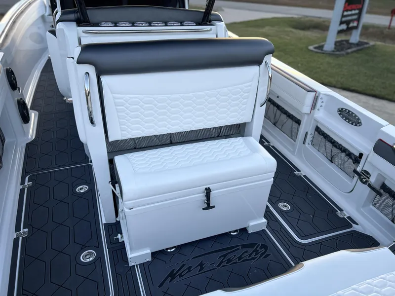 Slide: The Image of 2025 Nor-Tech 390 Sport boat interior with white seating and black flooring. - 8
