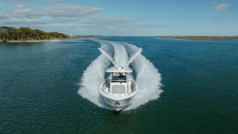 Slide: The Image of 2022 Pursuit S 328 boat cruising on open water. - 10
