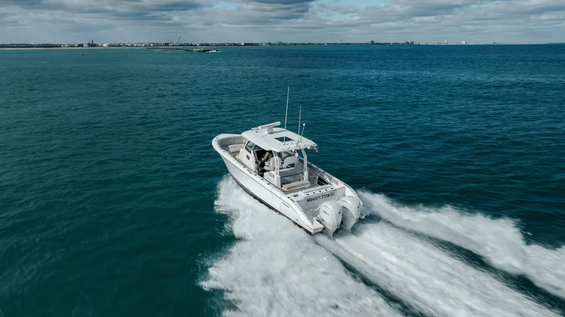 Slide: The Image of 2022 Pursuit S 328 boat cruising on open water. - 14