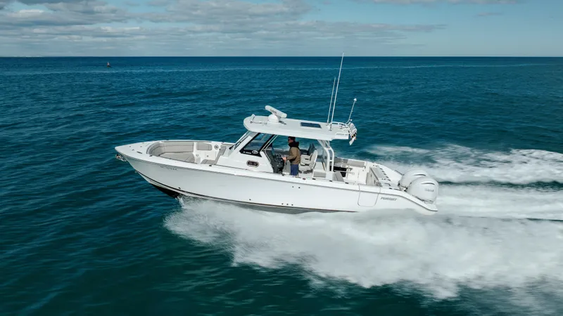 Slide: The Image of 2022 Pursuit S 328 boat cruising on open water. - 15