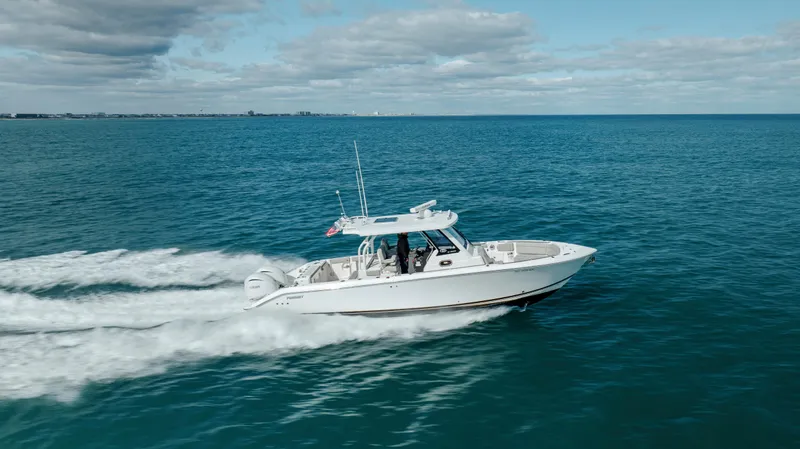 Slide: The Image of 2022 Pursuit S 328 boat cruising on open water. - 19