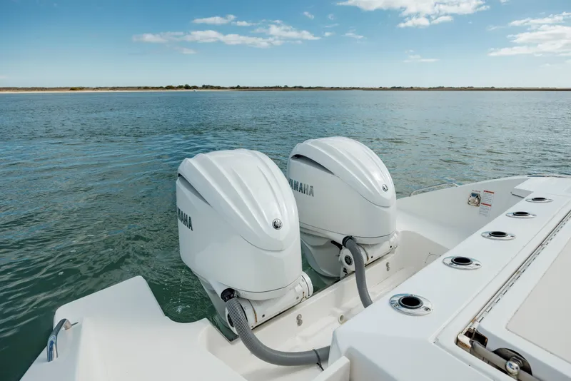 Slide: The Image of 2022 Pursuit S 328 boat with twin Yamaha outboard engines on water. - 24