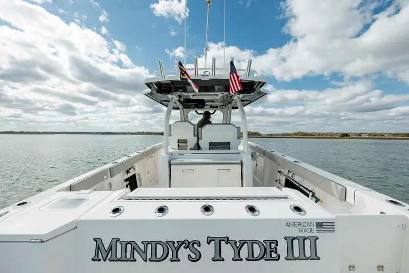 Slide: The Image of 2022 Pursuit S 328 boat named Mindy's Tyde III on open water under a cloudy sky. - 25