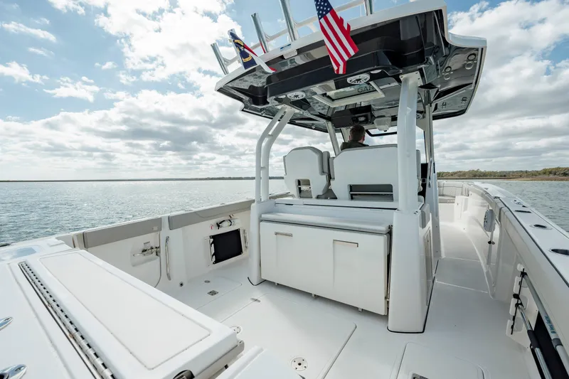 Slide: The Image of 2022 Pursuit S 328 boat interior with seating and American flag. - 26
