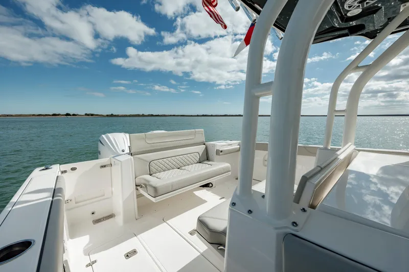 Slide: The Image of 2022 Pursuit S 328 boat interior with seating, on a sunny day. - 28