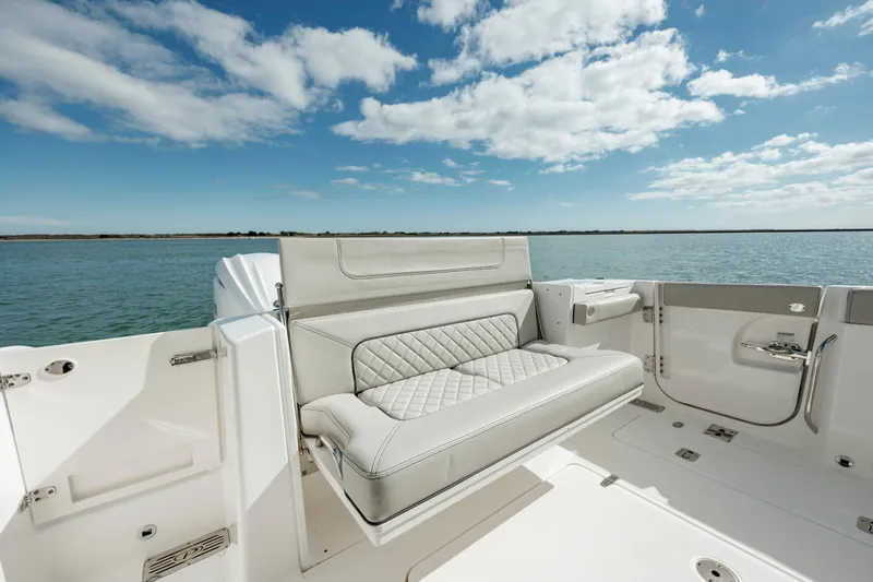 Slide: The Image of 2022 Pursuit S 328 boat with luxurious seating on a sunny day. - 29