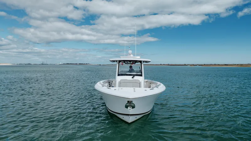 Slide: The Image of 2022 Pursuit S 328 boat on open water under blue sky. - 3