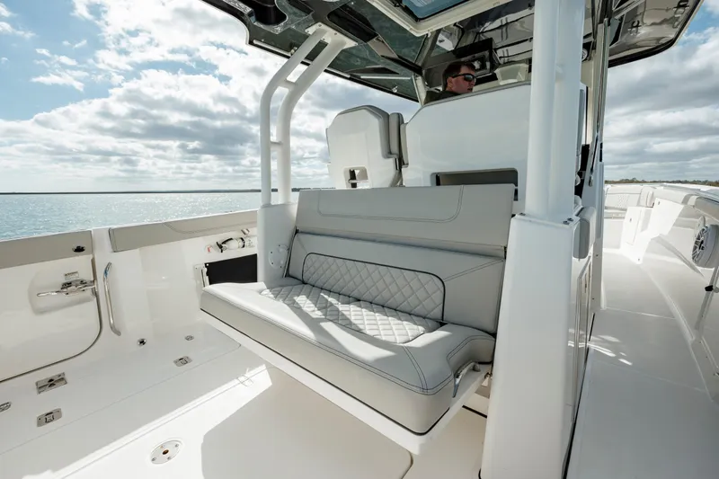 Slide: The Image of 2022 Pursuit S 328 boat interior with cushioned seating and ocean view. - 30